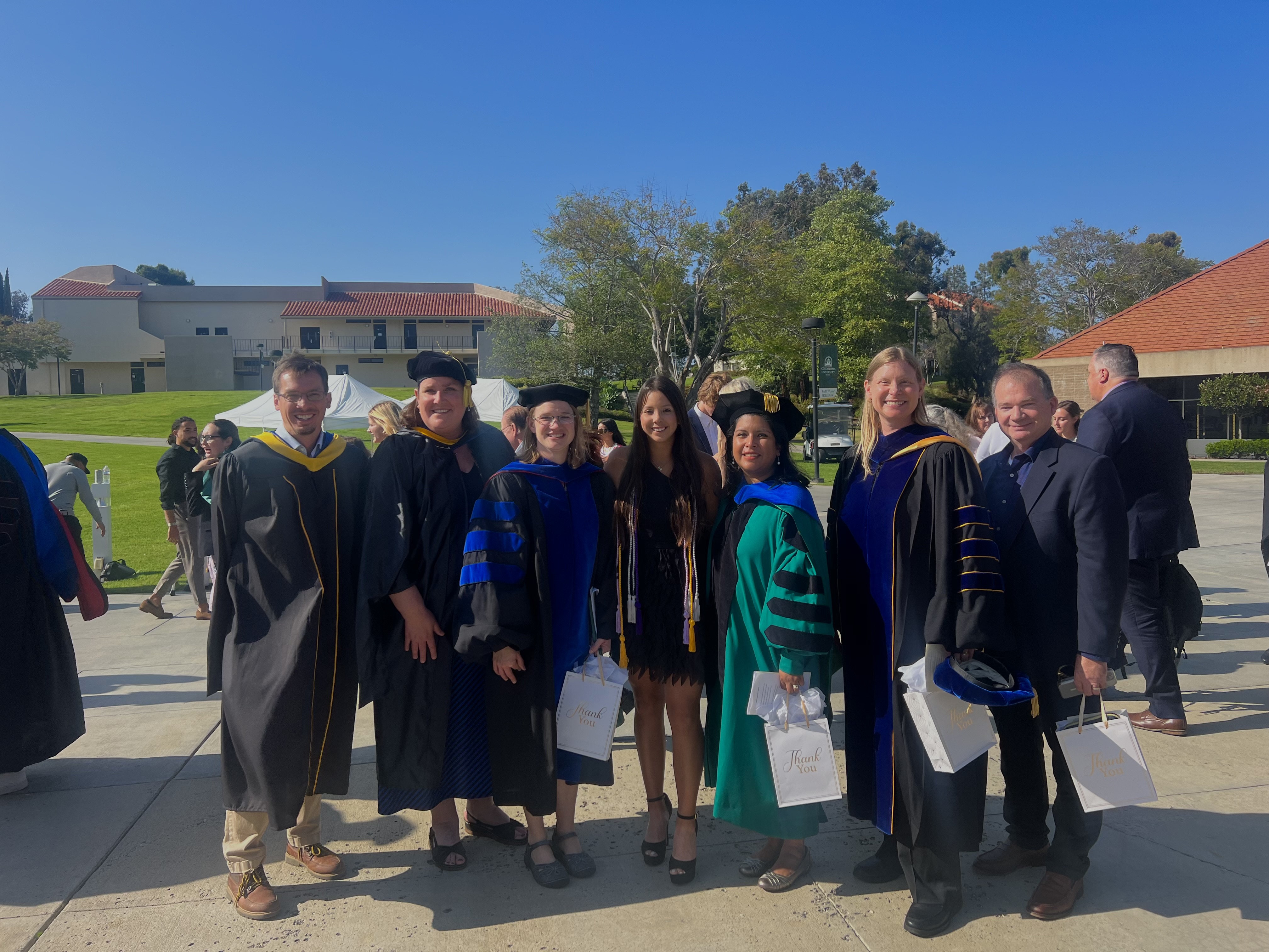 Tiffany Carrillo and her Concordia professors celebrate her graduation in 2024